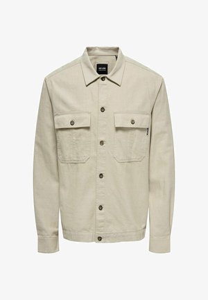 Beige knapjakke med lange ærmer, to brystlommer, brune knapper og krave, lavet af struktureret stof.