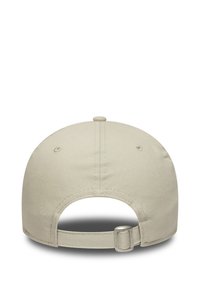 Gorra de béisbol beige con parte trasera redondeada y cierre de correa. Hecha de un tejido suave con una sutil textura y un detalle de costura en la parte superior.
