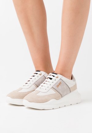 Beige and white sneakers made of suede and synthetic material, featuring a textured side panel, smooth finish, and contrasting laces.