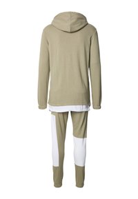 Olivově zelená mikina s kapucí a dlouhými rukávy, spárovaná s těsnými joggery s olivovým a bílým vzorem. Měkká, strukturovaná tkanina.