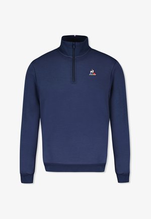 Felpa navy a zip corta realizzata in tessuto morbido. Presenta un'emblema del marchio sul petto e polsini a coste. Design semplice e classico.