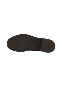 Suela de zapato de goma negra con una superficie texturizada, que presenta un área suave cerca del talón y un diseño estriado para tracción.