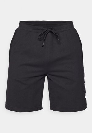 Schwarze Sportshorts aus weichem Stoff, mit einem Kordelzugbund, Seitentaschen und bedruckten Akzenten an den Seiten.