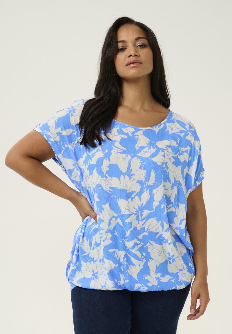 Light blue floral blouse with short sleeves, loose fit, and a round neckline. Features subtle texture and elastic hem for added shape.