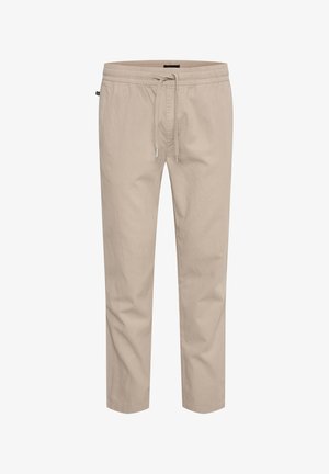 Beige katoenen broeken met een elastische tailleband, trekkoordsluiting en eenRelaxte pasvorm. Gladde textuur zonder patronen of versieringen.