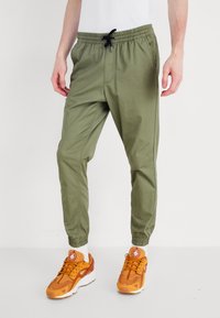 Jack & Jones JJIGORDON JJLANE VEGA - Trousers - deep lichen green
