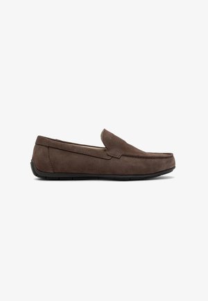 Brown suede slip-on loafers with a low-profile black rubber sole, featuring a smooth, textured upper and minimal stitching detail.