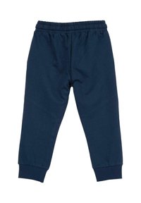 Pantalon en coton marine avec une taille élastique, une coupe fuselée et des poignets côtelés. Texture lisse, sans motifs ni accessoires visibles.