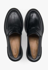 Pair of black leather slip-on loafers with rounded toes and tan insoles, viewed from above on a white background.