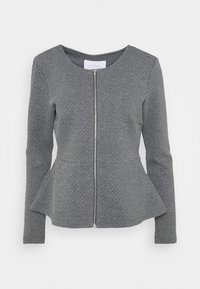 Veste peplum grise en tissu texturé, avec un col rond, des manches longues et une fermeture éclair frontale.