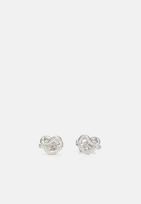 Silver stud earrings featuring an intertwined knot design with small clear accents, smooth surface with polished finish, and sleek metallic texture.