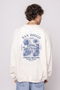 Krémová mikina so modrou grafikou palmy a dizajnom budovy, s textom "SAN DIEGO" a "KDE SA SPLNIA SNY".