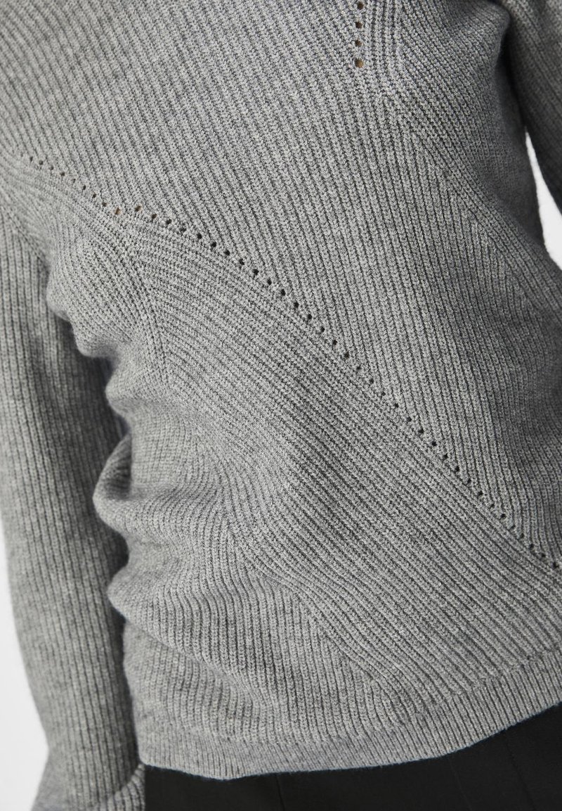 Szary sweter z prążkowanym wzorem, charakteryzujący się diagonalnymi splotami i subtelnymi dziurkami, o miękkiej fakturze i dopasowanym kroju.