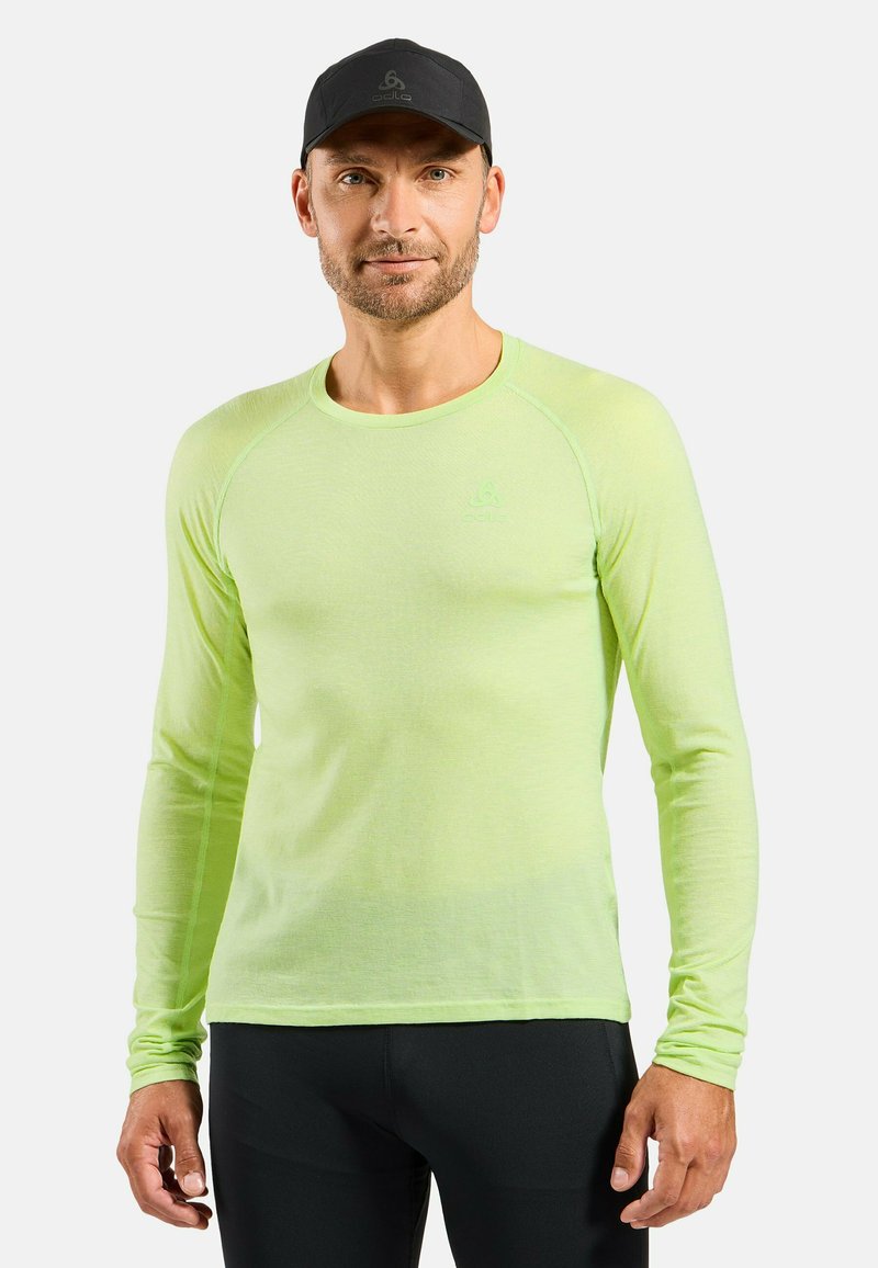 Long-sleeve, light green athletic shirt made of breathable fabric, featuring a rounded neckline and logo on the chest.
