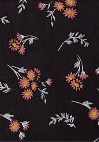Black fabric with a textured surface featuring pink daisies and gray leaves in a scattered floral pattern.