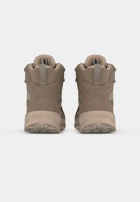 Botas de caminhada castanhas feitas de materiais em camurça e têxtil, com um colarinho acolchoado, ilhós reforçados e solas de borracha texturizadas.