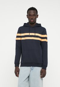Navy blue hoodie with orange stripes across the chest, drawstring hood, kangaroo pocket, and ribbed cuffs. Soft cotton blend fabric.