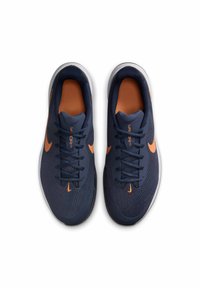 Baskets de sport navy avec des accents orange, tige en mesh texturé, bout rond et système de laçage traditionnel. Semelle blanche pour un meilleur amorti.