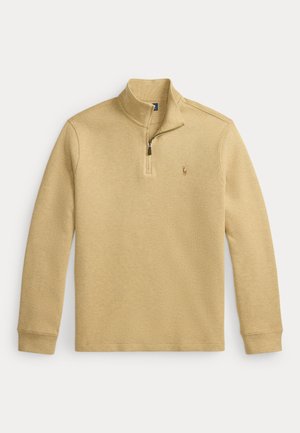 Beżowy sweter z zamkiem do połowy, długimi rękawami, ściągaczami na mankietach, stójką oraz małym haftowanym logo konia na lewej piersi.