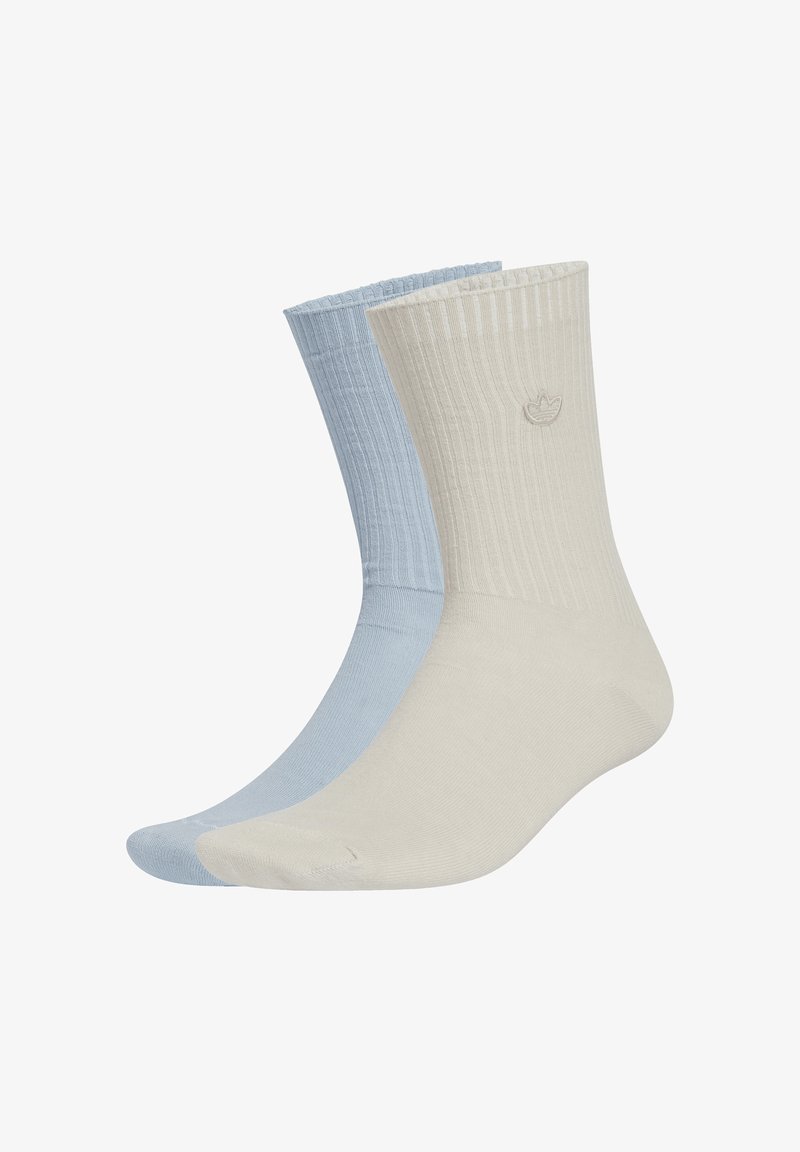 Two pairs of ribbed socks; one in light blue and the other in beige. Both have a soft texture and a logo near the top.