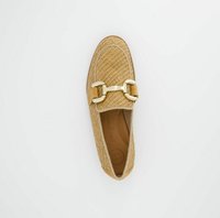 Textured brown woven slip-on shoe with a rounded toe, featuring a gold hardware accent and a flexible sole. The interior is lined in tan.