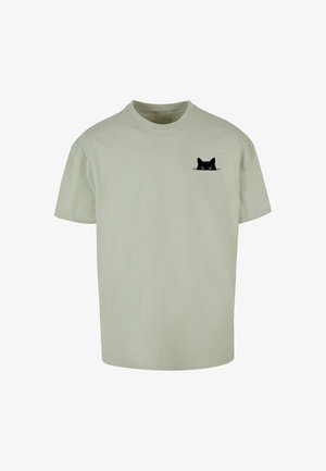 Svetlozelené bavlnené tričko s krátkymi rukávmi, s grafikou čiernej mačky na ľavej hrudnej oblasti. Jednoduchý dizajn s okrúhlym výstrihom.