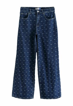 Denim wide-leg trousers in dark blue with a repeated small white bow pattern. Features five pockets and a button closure.