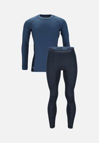 Ensemble de couche de base thermique en bleu foncé. Haut à manches longues avec texture côtelée et coutures contrastées ; leggings avec taille élastique et texture assortie.