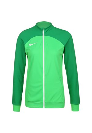 Grüne Zip-Jacke mit kontrastierenden Grüntönen, leichtem Stoff, gerippten Bündchen und einem weißen Logo auf der Brust.