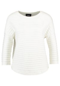 Pull à rayures blanches avec un col rond et des manches trois-quarts. Présente un tissu texturé et un ourlet légèrement courbé.