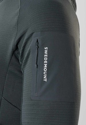 Dark gray fabric sleeve with a vertical zippered pocket and "SWEDEMOUNT" printed in white along the pocket.