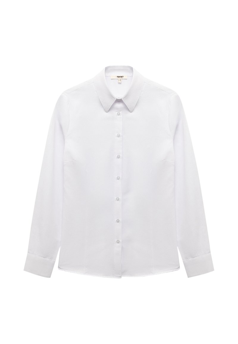 Camicia bianca a maniche lunghe con colletto a punta, realizzata in tessuto liscia. Presenta una chiusura frontale con bottoni e una vestibilità sagomata.