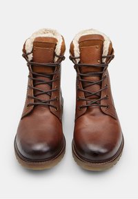 Hnedé kožené šnurovacie čižmy s kožušinovým podšívam, zaoblenou špičkou a gumovou podrážkou, zobrazené spredu na bielom pozadí.