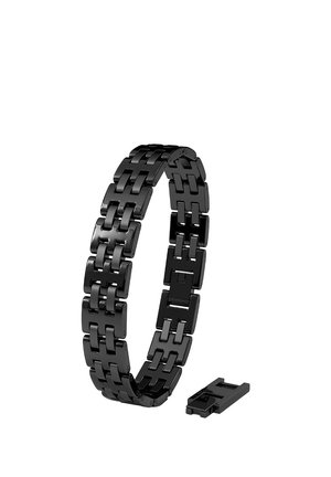 Black metal watch band with removable link separated and placed next to the band on a white background.
