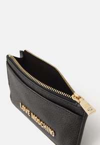 Black textured leather cardholder with gold hardware, featuring a zip closure and the embossed logo "LOVE MOSCHINO" on the front.