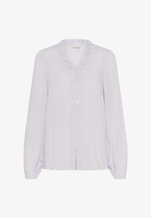 Heledad lavendlitop, millel on pikad varrukad, volangiga V-kaelus ja esine nööbistamine vasteid kasutades. Sile, kergelt tekstureeritud kude.