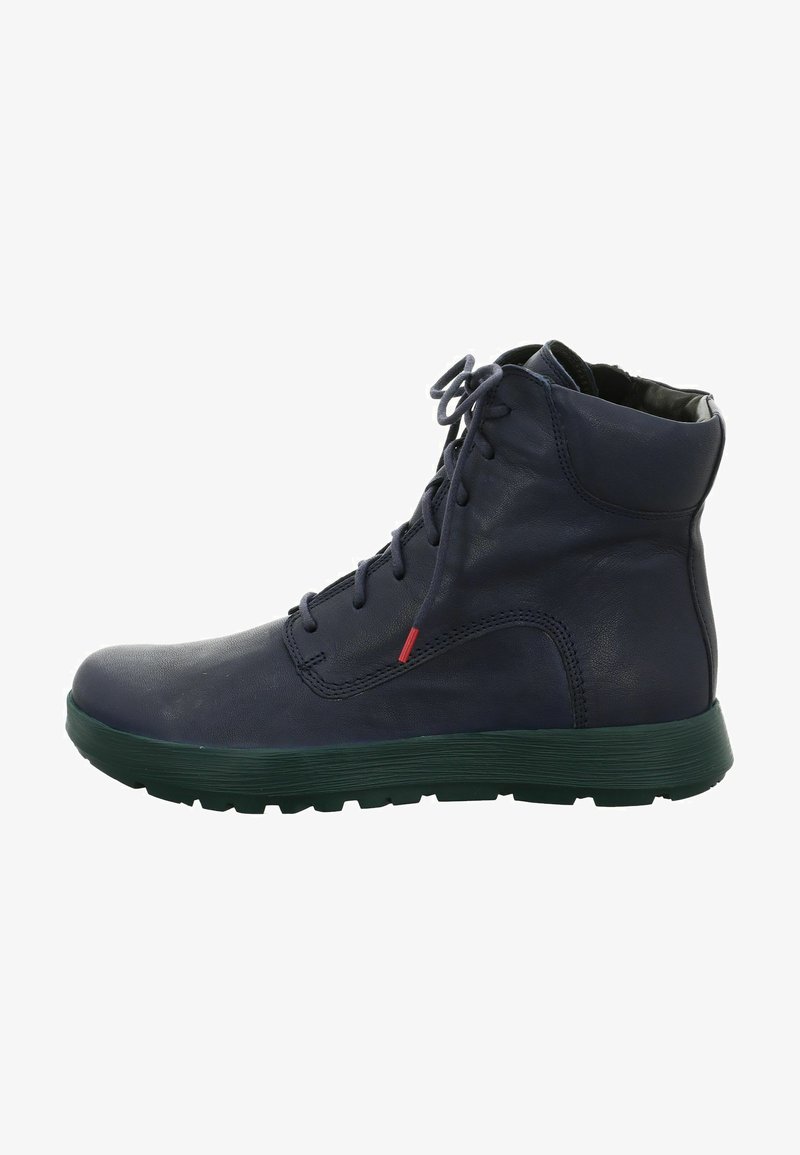 Navy leather boot with a textured finish, laces, and red accent, features a thick green rubber sole and mid-height design.