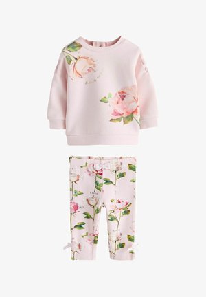 Hele roosa väikelapse pusa ja sobivad retuusid roosimustri ja roheliste lehtedega, retuusidel väikeste paeladega.