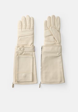 Luvas de couro em tom creme, apresentando seções para os dedos, um fecho de zíper e um bolso em uma das luvas. Textura suave com acabamentos costurados.