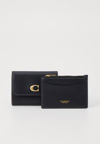 Black leather wallet with gold hardware, featuring a clasp and a zippered cardholder. Notable white stitching accents detail.