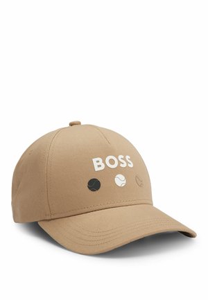 Tan baseball cap with curved brim. Features "BOSS" logo in white and tennis ball icons in black, white, and light gray. Made of fabric material.