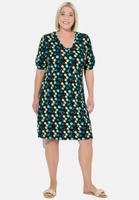 Schwarzes Kleid mit türkisfarbenen, gelben und wei�ßen kreisförmigen Mustern. Kurze Puffärmel, Rundhalsausschnitt, knielang, aus einem weichen Stoff gefertigt.
