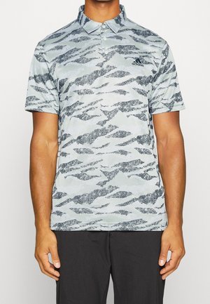 Polo shirt with a light gray background and black wavy patterns, short sleeves, collar, and an Adidas logo on the left chest.