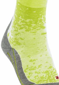 Grün-weiße gemusterte Socke mit grauem Fersenbereich, die ein strukturiertes Design und kontrastierende gelbe Nähte an der Naht aufweist.