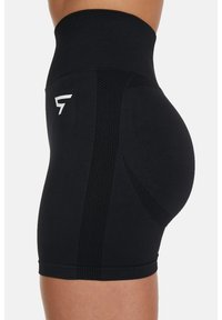 High-waisted black athletic shorts with a smooth texture, mesh panels on the sides, and a white logo on the waistband.