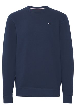 Tamsiai mėlynas džemperis, pagamintas iš minkštos medžiagos, su apvaliu kaklu, ilgomis rankovėmis ir maža logo ant krūtinės, turintis rišo apdailą apačioje ir rankovėse.