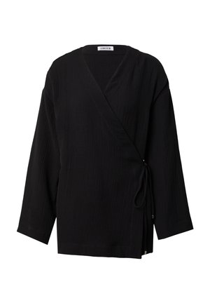 Black wrap top with long sleeves, textured fabric, V-neckline, side tie detail, and a relaxed fit. No visible patterns or hardware.