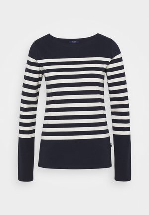 Chemise bleu marine à manches longues avec des rayures horizontales blanches sur la poitrine et les bras, parties supérieures et inférieures unies bleu marine.