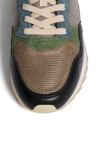 Sportliche Sneakers mit einem Obermaterial aus Mesh und Wildleder in Grün, Grau und Braun, mit schwarzen Lederelementen und beigen Schnürsenkeln auf einer weißen Sohle.