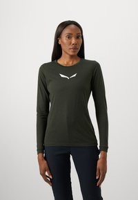 Olive green long-sleeve shirt with a round neckline and white logo detailing on the chest. Made of soft, lightweight fabric.